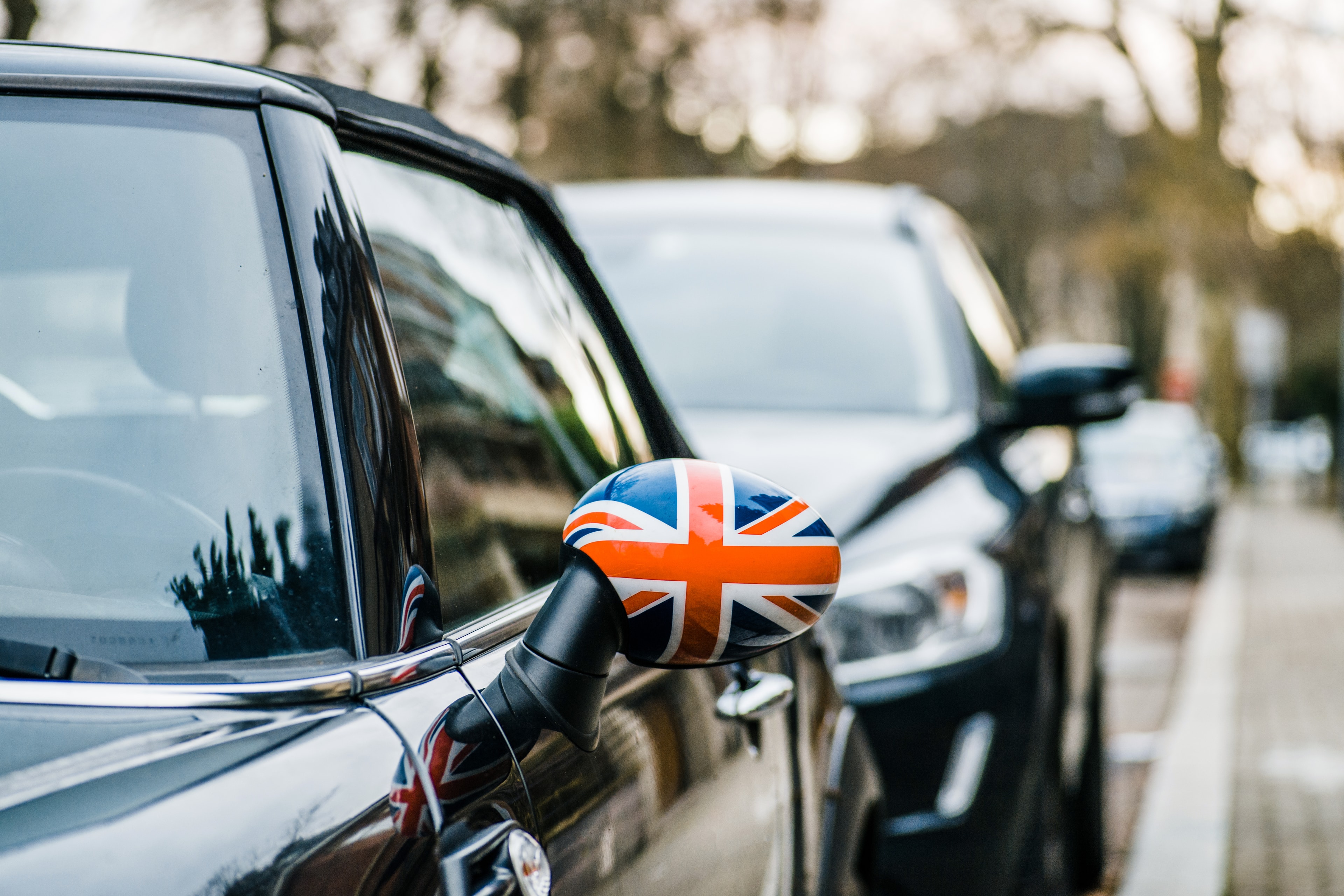 Union Jack flag on the mirror of a parked Mini Cooper car