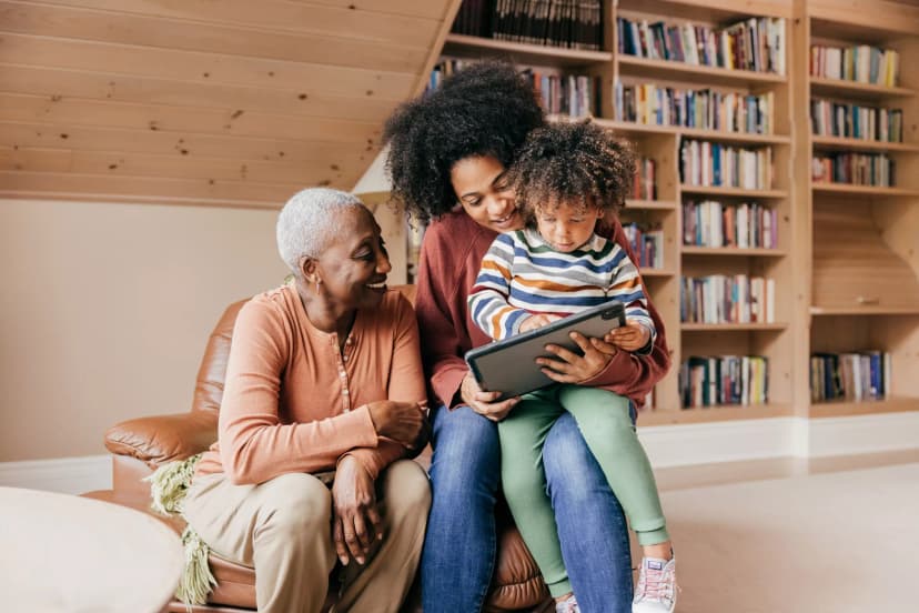 family of three looking at tablet